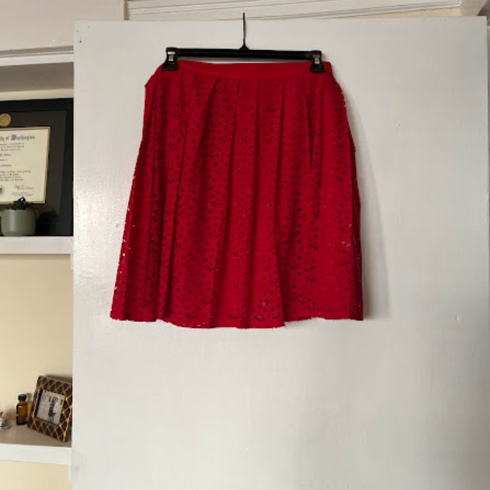 Red pleated skirt with cut-out detail